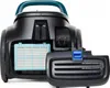 A close-up view of the back of a black vacuum cleaner, showing an open compartment with a light blue HEPA filter. A black cover with a blue latch is partially detached. Podgląd zdjęcia produktu