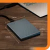 An external hard drive connected to a laptop on a wooden desk. Produktbild-Vorschau