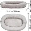 Two views of a gray, oval-shaped pet bed with dimensions indicated by measurement lines and text. Anteprima dell’immagine prodotto