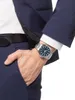A man's hand wearing a watch is placed in the pocket of his suit. Náhľad obrázku produktu