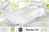 A white duvet and pillow are displayed on a bed in a brightly lit room. Produktbild-Vorschau