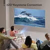 A family is watching a movie projected by a mini projector onto a wall. Produktbild-Vorschau