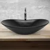 A black ceramic vessel sink with a chrome faucet is shown on a wooden countertop against a textured gray wall. Náhľad obrázku produktu