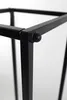 A close-up view of the corner joint of a black metal firewood rack. Produktbild-Vorschau