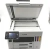 A white Canon MAXIFY GX 7050 Multifunction Printer with its lid open. Produktbild-Vorschau