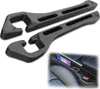 Two black car seat gap fillers are shown against a white background. A small inset image shows the gap fillers installed in a car's center console, holding a smartphone and a car key. Produktbild-Vorschau
