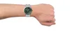 A person's wrist wearing a watch. Voir les images du produit