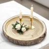 A wooden tray with two candles and a small floral arrangement on a marble surface. Náhľad obrázku produktu