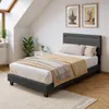 A bedroom scene with a bed, nightstand, and plants. Náhled obrázku produktu