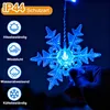 A hand holding a blue LED snowflake light against a dark blue background, with feature icons and text on the left. Náhled obrázku produktu