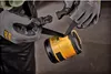 Hands wearing gloves are holding a yellow and black device, with a strap being connected. Podgląd zdjęcia produktu