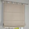 A close-up view of a beige linen Roman blind hanging from a metal curtain rod. Produktbild-Vorschau