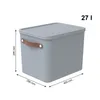 A gray storage box with a brown handle and a lid, shown with dimensions and capacity indicated. Produktbild-Vorschau