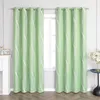 Two green curtains with a white wavy pattern hang on a curtain rod in front of a window. To the left is a white fireplace mantel with a calendar. To the right is a small blue table with a vase of flowers. Produktbild-Vorschau