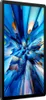 A black tablet is shown in a side profile, displaying a vibrant, abstract wallpaper on its screen. Voir les images du produit