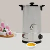 A silver wax melter with a dispenser is shown on a table, with spa-like items like candles and rolled towels in the background. Produktbild-Vorschau