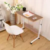 A white chair is placed next to a wooden table with wheels in a room with wooden floors and curtains. Produktbild-Vorschau
