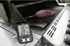 A digital thermometer is placed on a grill next to a piece of raw meat. Produktbild-Vorschau