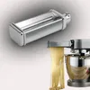 A Kenwood spaghetti cutter attachment is shown, with one part in the foreground and another attached to a stand mixer, producing spaghetti. Produktbild-Vorschau