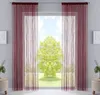 A window with burgundy string curtains and a view of a green tree outside. Produktbild-Vorschau