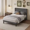 A bedroom scene with a bed, nightstand, and wall art. Náhľad obrázku produktu