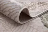 A close-up view of a rolled-up rug, showing its texture and pattern. Produktbild-Vorschau