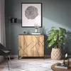 A modern living room scene featuring a wooden cabinet with geometric patterns, a floor lamp, a chair, a plant, and a rug. Voir les images du produit