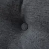 A close-up view of a dark gray tufted fabric with a single button. Produktbild-Vorschau