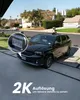 A black minivan is parked in a driveway with a close-up inset of its license plate. The background shows a suburban neighborhood with houses and trees. Produktbild-Vorschau