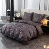A neatly made bed with floral patterned bedding in a bedroom setting. Anteprima dell’immagine prodotto