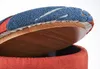 Close-up view of the lid of an open storage ottoman, showing the upholstered top and the wooden underside. Podgląd zdjęcia produktu