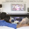 A couple relaxing on a couch watching TV and using a wireless keyboard. Produktbild-Vorschau