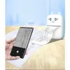 A hand holds a smartphone displaying text and diagrams, while a small, cute printer prints out a roll of paper with similar content. Podgląd zdjęcia produktu