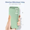 A hand holding a light green phone case against a white background. Produktbild-Vorschau