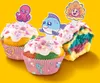 Three colorful cupcakes with ocean-themed toppers and wrappers, set against a bright yellow background. Produktbild-Vorschau