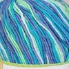 A close-up view of a ball of multi-colored yarn. Produktbild-Vorschau