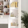 A vanity table with shelves filled with makeup and skincare products, with a closed cabinet door on the right side. Produktbild-Vorschau