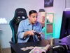 A young man is playing a video game on a computer, sitting in a gaming chair. Náhled obrázku produktu