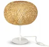 A table lamp with a woven bamboo shade and a white metal base and stem, shown against a white background. Produktbild-Vorschau