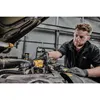 A mechanic is using a DeWALT cordless ratchet wrench to work on a car engine. Produktbild-Vorschau
