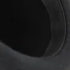 A close-up view of the brim of a black hat, showing the texture of the fabric and a black elastic band. Anteprima dell’immagine prodotto