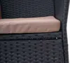 A close-up view of a black rattan chair with a beige cushion. Produktbild-Vorschau