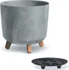 A planter pot with a concrete effect and wooden legs, shown with a separate saucer. Voir les images du produit