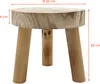 A wooden stool with three legs, shown from the front. Produktbild-Vorschau