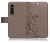 A brown flip case for a Samsung Galaxy Z Fold 3 with a floral and butterfly embossed pattern. Produktbild-Vorschau