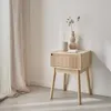 A wooden nightstand with a drawer is placed next to a sheer curtain. Produktbild-Vorschau