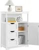 A white wooden cabinet with three drawers and an open door, displaying books, a decorative pumpkin, and a woven basket. Produktbild-Vorschau
