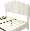 A close-up view of a bed frame with a beige upholstered headboard and wooden slats. Produktbild-Vorschau