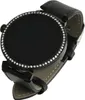 A close-up studio shot of a black smartwatch with a diamond-encrusted bezel and a black leather strap, isolated on a white background. Podgląd zdjęcia produktu