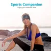 A woman wearing a sports headband with integrated headphones sits outdoors by the water. Náhľad obrázku produktu